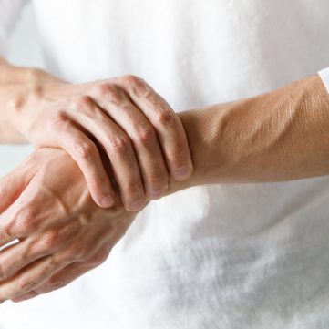 Closeup,Of,Male,Arms,Holding,His,Painful,Wrist,Caused,By